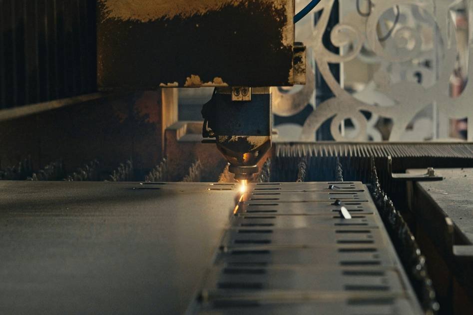 Industrial plasma cutter in action cutting steel plate with bright sparks